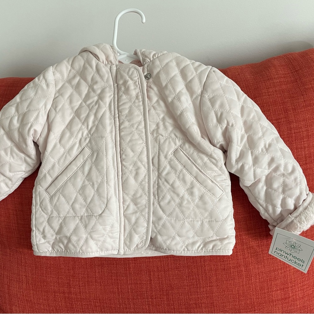 New with tags, 9 month size fleece lined coat for baby in light pink.